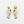 Load image into Gallery viewer, Pair of gold seahorse earrings on a white background
