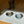Load image into Gallery viewer, Dog standing on a patterned mat with two bowls, one of which contains food.
