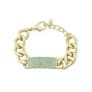 Gold chain bracelet with a green gemstone panel on a gray background
