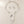 Load image into Gallery viewer, A silver-toned jewelry set featuring a textured abstract pendant necklace and matching circular drop earrings, displayed on a neutral gray background.
