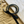 Load image into Gallery viewer, Black and gold hair ties with a black ribbon on sand and marble surface
