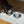 Load image into Gallery viewer, Dog eating from a bowl on a branded mat with a wooden floor background
