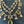 Load image into Gallery viewer, Delicate gold necklace with green gemstones on a dark surface
