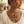 Load image into Gallery viewer, A woman wearing a bohemian-style silver necklace with a snake, beads, and a dangling flower charm, paired with a cream-colored t-shirt in a softly lit indoor setting.
