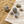 Load image into Gallery viewer, Silver spherical earrings on a textured surface with sand and stones
