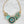 Load image into Gallery viewer, Decorative necklace with circular design and turquoise stones on a dark surface
