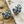 Load image into Gallery viewer, Pair of decorative earrings on a sandy surface with shells.

