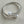 Load image into Gallery viewer, Two pearl-studded silver bracelets on a light gray textured surface
