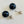 Load image into Gallery viewer, Black spherical earrings with gold posts on a light gray background
