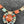 Load image into Gallery viewer, Colorful necklace with large central gemstone on a dark surface
