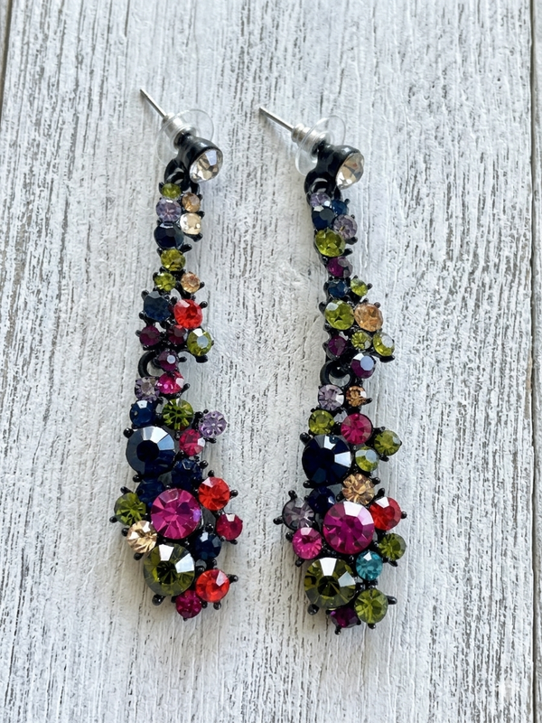 Multicolored beaded earrings on a light wooden surface