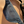 Load image into Gallery viewer, Black bag with a strap on a beige surface
