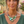 Load image into Gallery viewer, Woman wearing a green and silver necklace outdoors with plants in the background

