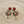 Load image into Gallery viewer, Ornate earrings with red gemstones on a sandy surface

