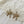 Load image into Gallery viewer, Gold bow-shaped earrings with rhinestones on a lace fabric background
