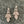 Load image into Gallery viewer, Pair of diamond earrings on a dark marble surface
