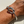 Load image into Gallery viewer, Silver knot bracelet on a wrist against a neutral background
