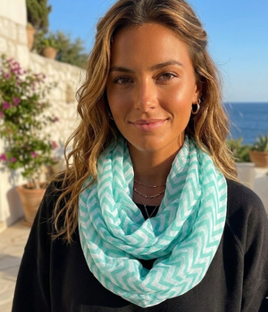 Woman wearing a turquoise patterned scarf with a scenic background