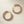 Load image into Gallery viewer, Gold hoop earrings with gemstone accents on a light wooden surface
