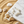 Load image into Gallery viewer, Star-shaped earrings on a marble surface with sand and shells around

