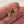 Load image into Gallery viewer, Two small metallic triangle-shaped objects held between fingers against a neutral background
