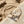 Load image into Gallery viewer, Silver bracelet with a heart and arrow design on a sandy surface
