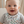 Load image into Gallery viewer, Baby wearing a colorful bib sitting in a crib
