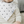 Load image into Gallery viewer, Child wearing a white bib with black cross patterns and a visible brand tag.
