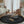 Load image into Gallery viewer, Children's room with a black play mat, toys, and furniture.
