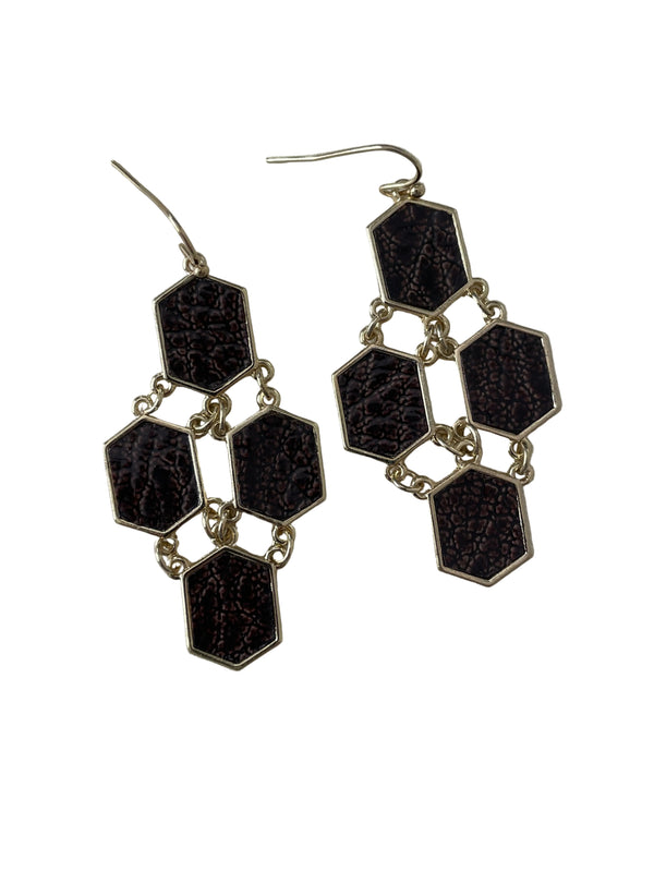 Hexagonal earrings with black and silver design on a light gray background