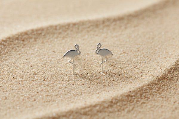 Flamingo-shaped earrings on a white background