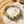Load image into Gallery viewer, Silver bracelet with green beads on a stone surface with sand and stones in the background
