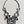 Load image into Gallery viewer, A statement bib necklace featuring a silver-tone chain and multiple circular and oval links adorned with faceted clear and dark gray rhinestones, displayed on a light wood background.
