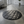 Load image into Gallery viewer, Round gray quilted mat in a modern room with large windows and a plant.
