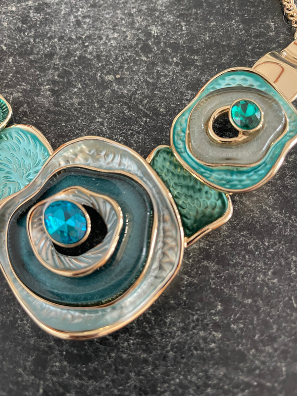 Close-up of a decorative bracelet with turquoise stones on a dark surface