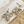 Load image into Gallery viewer, Gold earrings with clear stones on a marble surface
