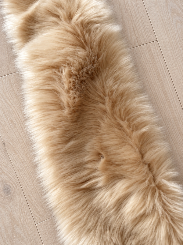 Close-up beige faux fur scarf on pale wood