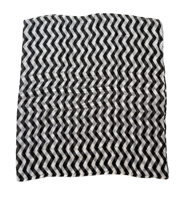 Black and white chevron patterned rug on a textured floor