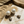 Load image into Gallery viewer, Pearl earrings on a textured surface with sand and leaf
