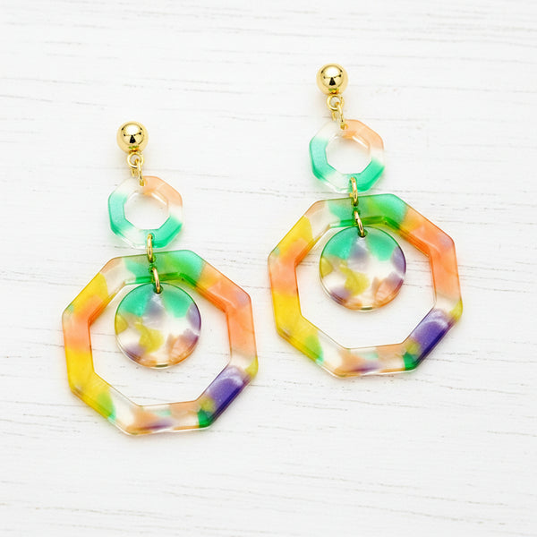 Colorful hexagonal earrings with gold accents on a white background