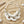 Load image into Gallery viewer, A statement necklace featuring large white mother-of-pearl disc pendants, layered with silver beaded chains, clear crystal beads, and a strand of pale pink pearls on a silver link chain, set against a light gray background.
