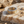 Load image into Gallery viewer, Gold ring on a textured stone surface with sand and shells around
