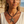 Load image into Gallery viewer, Woman wearing a starfish necklace on a beach

