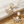 Load image into Gallery viewer, Gold earrings with opal stones on a marble and sand background
