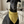 Load image into Gallery viewer, Black dog wearing a yellow bandana sitting on a couch.
