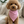 Load image into Gallery viewer, Small brown dog wearing a pink bandana sitting on a beige couch.
