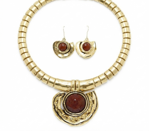 Gold-tone jewelry set featuring a chunky beaded collar necklace with a large crescent-shaped pendant and matching crescent drop earrings, each with a round reddish-brown cabochon stone, shown on a white background.