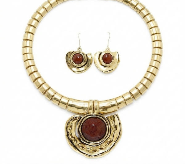 Gold-tone jewelry set featuring a chunky beaded collar necklace with a large crescent-shaped pendant and matching crescent drop earrings, each with a round reddish-brown cabochon stone, shown on a white background.