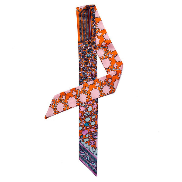 Colorful patterned scarf with a mix of orange, pink, and blue on a white background