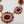 Load image into Gallery viewer, Ornate earrings with red and orange gemstones on a white background
